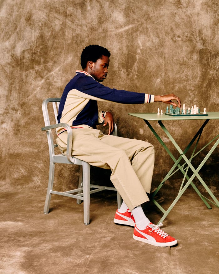 Model playing chess in Puma shoes.